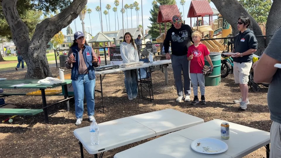 Malia Vella discussing housing & infrastructure at the potluck
