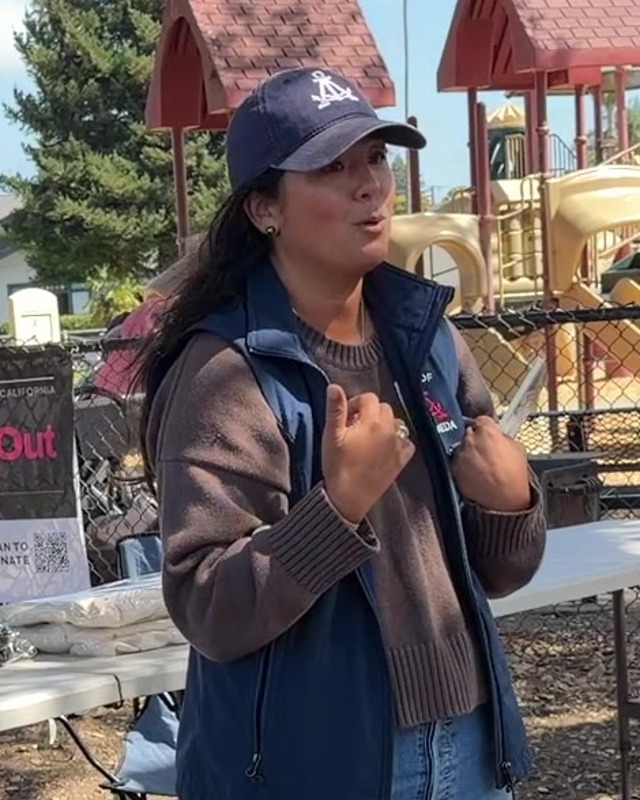 Malia Vella speaking at the potluck