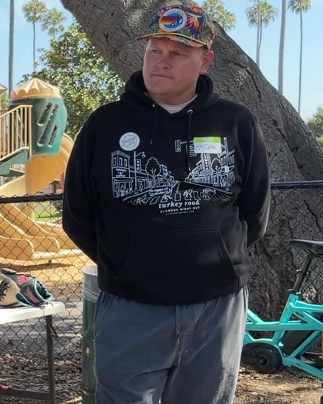 Tyler Savage speaking at the potluck